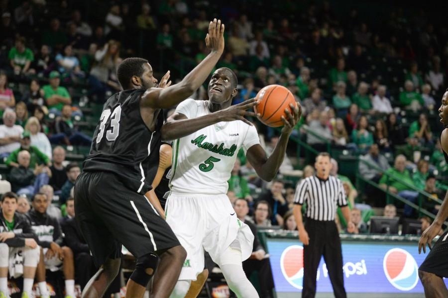 Marshall’s Cheikh Sane holds as Herd men’s basketball takes on Concord University in an exhibition game Nov. 8 at the Cam Henderson Center.