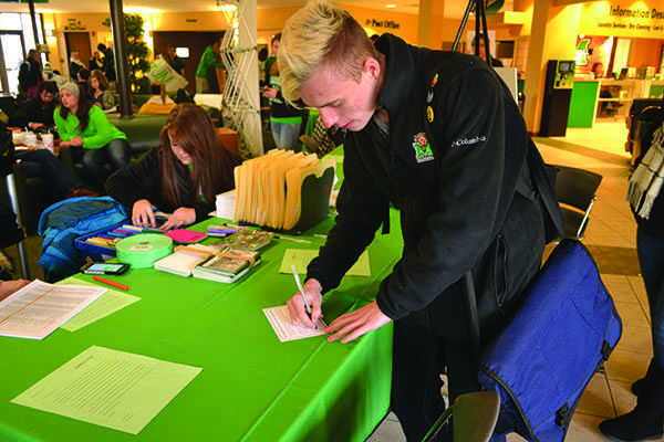 Levi Meachun writes a note thanking a donor for his or her
contribution to Marshall University scholarships and funding at
Thank-A-Donor Day Tuesday in the Memorial Student Center.