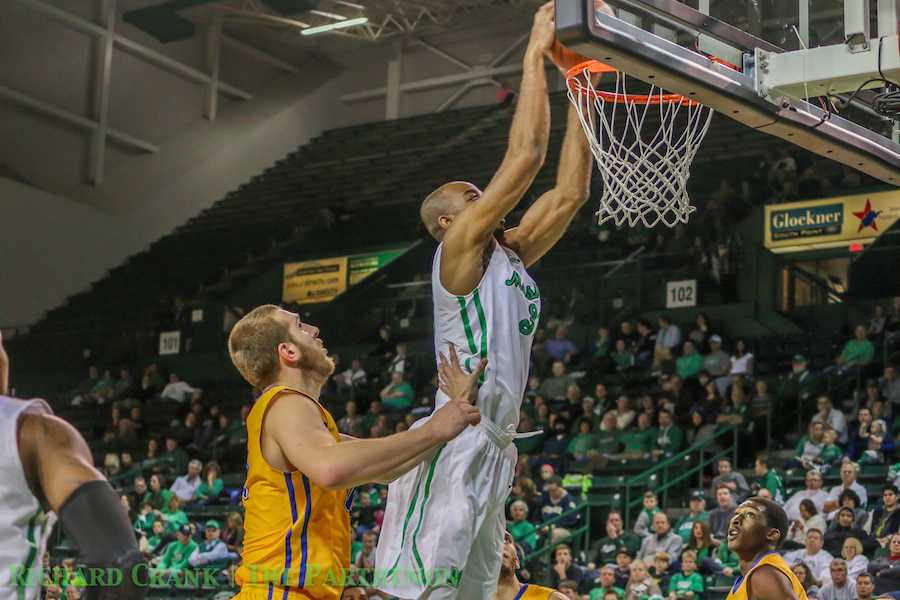 Senior center JP Kambola dunks against Morehead State University as Marshall men's basketball falls to the  Eagles Wednesday at the Cam Henderson Center. 