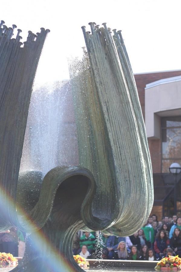 Students and faculty of Marshall University, family, friends and loved ones of those lost in the 1970 plane crash gather outside on the Memorial Student Center plaze on Thursday, Nov. 14, 2013 to pay tribute on the 43rd anniversary of the crash.