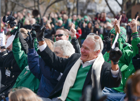 Members of the Marshall University community at the Memorial Fountain Ceremony participate in Rev. Steve Harvey’s “Live it, Love it, Loyal to it,” a team tradition, Friday on the Memorial Student Center plaza.