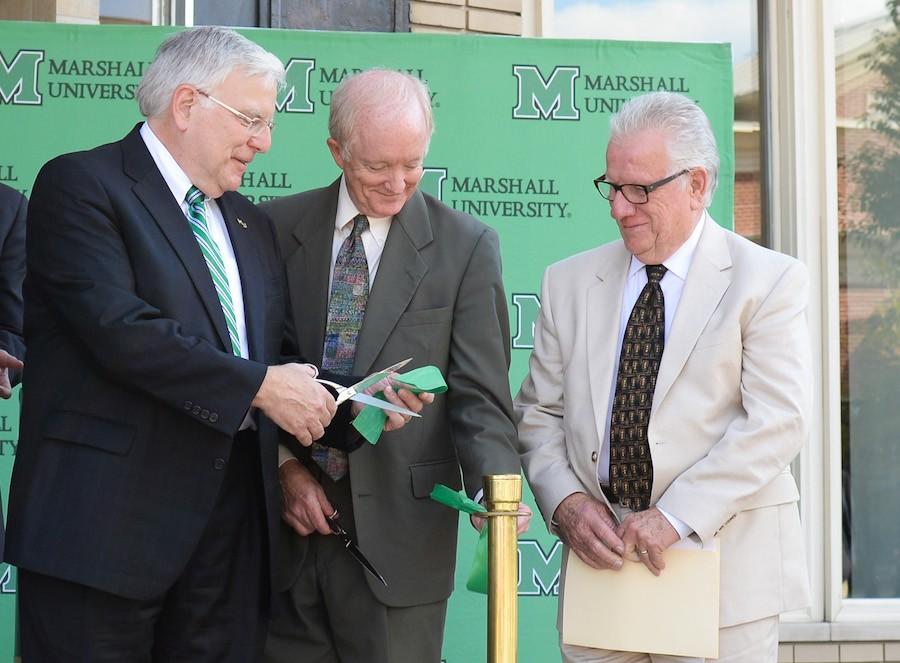 Marshall+President+Stephen+J.+Kopp+shares+a+piece+of+the+ribbon+with+Don+Van+Horn%2C+dean+of+the+College+of+Arts+and+Media+during+Marshall+University%E2%80%99s+Visual+Arts+Center+ribbon-cutting+ceremony+on+Thursday%2C+Sept.+18.