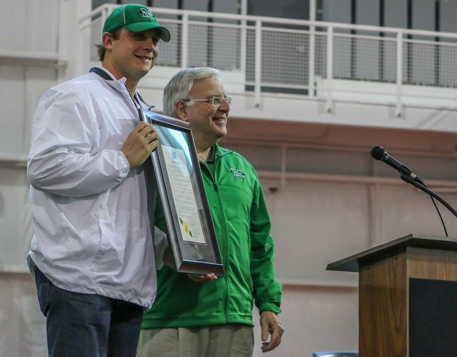 Marshall University President Stephen J. Kopp presents former quarterback Chad Pennington with a plaque at the dedication of the Chad Pennington Marshall Athletic Hall of Fame Nov. 15 at the Chris Cline Athletic Complex. 