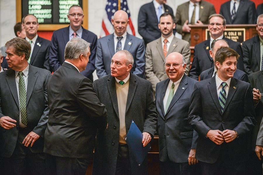 Marshalls head football coach Doc Holliday and Interim President Gary White commemorate Senate Resolutions that honor the Marshall football team Wednesday in Charleston.