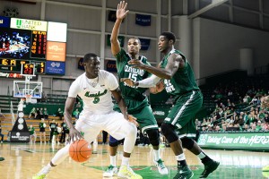 Marshall’s Cheikh Sane rushes past Anton Grady and Marlin Mason as the Herd mens basketball team takes on Cleveland State University at the Cam Henderson Center.