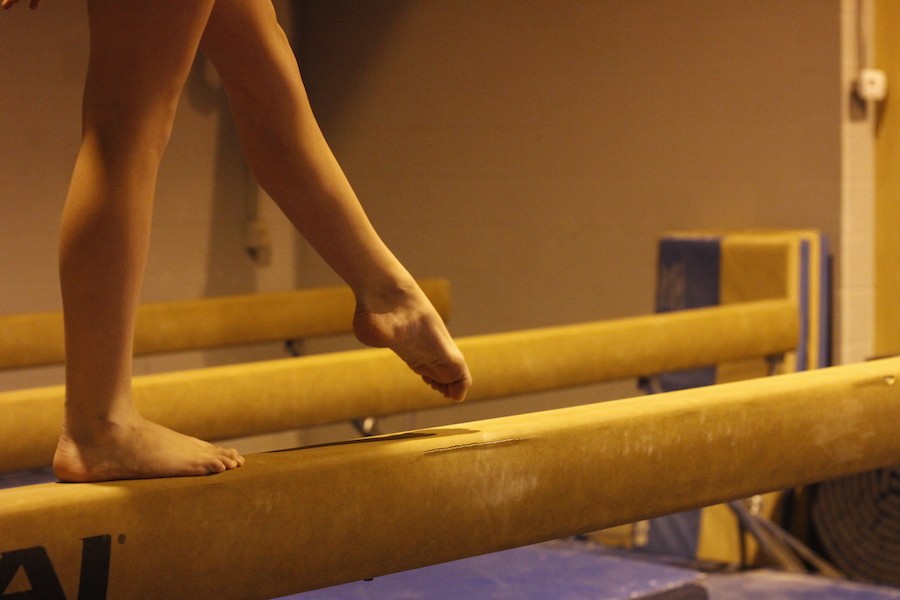 A gymnast walks a balance beam at AMP Gymnastics.
