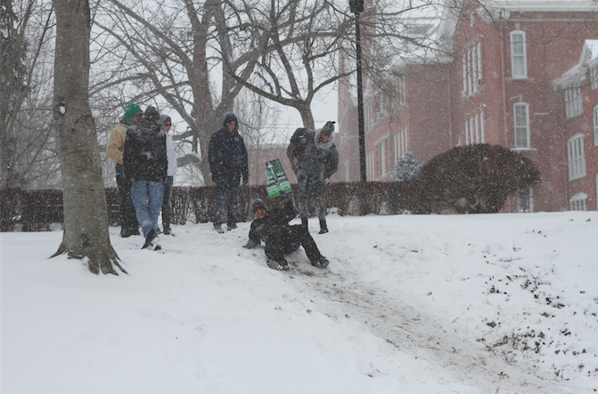 Students take advantage of the snow day Feb. 16 by sliding through the snow drifts on campus, instead of catching up on homework. 