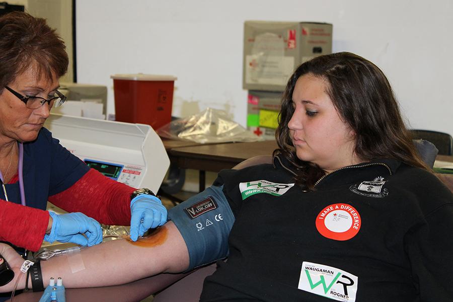 American Red Cross employee takes Mara Rhoades' blood during a blood drive at Marshall University Wednesday.