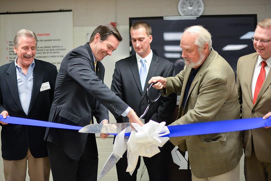 Rep. Evan Jenkins assists in cutting the ribbon during a ceremony to celebrate The Healing Place's 30-bed expansion Thursday in Huntington. The facility plans to expand to 100 beds later this year.  