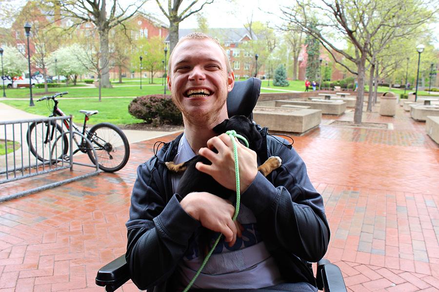 Michael Cantley, criminal justice major, enjoys his moment with a puppy Wednesday during the Pet-A-Puppy event on the Memorial Student Center Plaza.