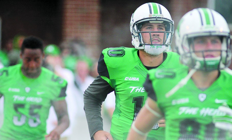 Gunnar Holcomb takes the field with the Herd as it faces Ohio University Sept. 13, 2014 at Joan C. Edwards Stadium. 