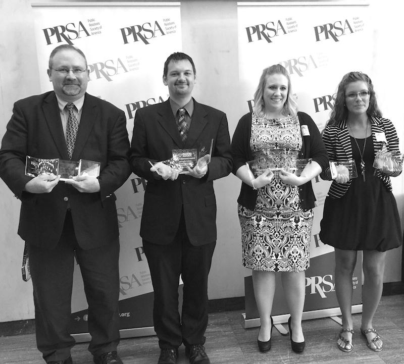LEFT TO RIGHT: Dr. Terry Hapney, associate professor of public relations at Marshall University, and three alumni from the MU PR program—Michael Circle, Amber Payne, and Ashley Peach--hold the 13 awards the Public Relations Society of America-West Virginia and East Central District organizations awarded the PR program at the  PRSA-WV Crystal Awards gala at the West Virginia State Capitol on Wednesday, June 17. 

