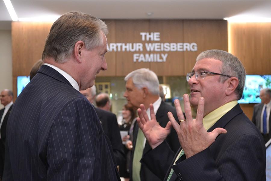 Presidential candidate Christopher G. Maples speaks with Huntington Mayor Steve Williams Thursday night at the Arthur Weisburg Family Engineering Complex.