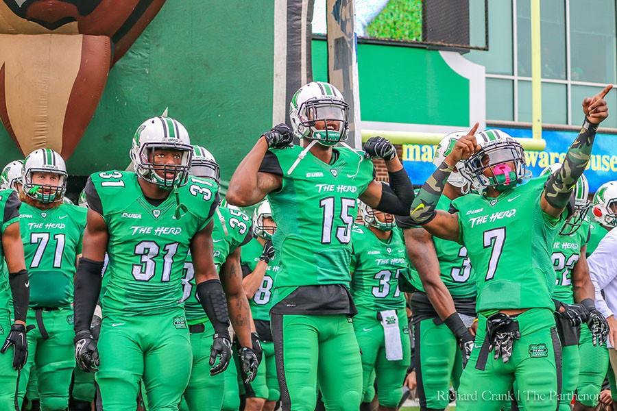 The Marshall University football team prepares to take the field for its Homecoming Game against the University of North Texas Saturday.