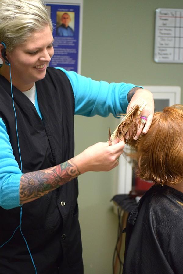 Hair stylist Morgan Workman gave free haircuts to the homeless Monday at Harmony House.