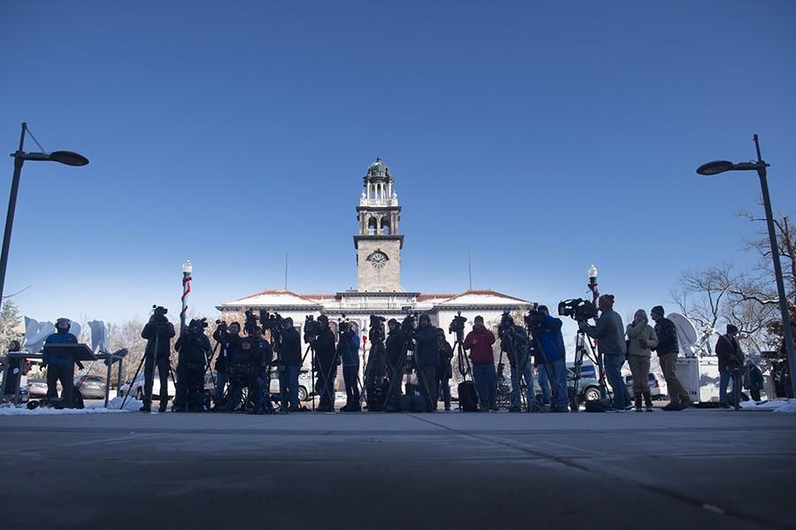 Members of the media gather outside the El Paso County Terry R. Harris Judicial Complex in Colorado Springs, Colo. Monday, Nov. 30, 2015, during the first court appearance for Colorado Springs Planned Parenthood shooting suspect Robert Dear. In the background of this photo is the Colorado Springs Pioneers Museum. (Mark Reis/The Gazette via AP)