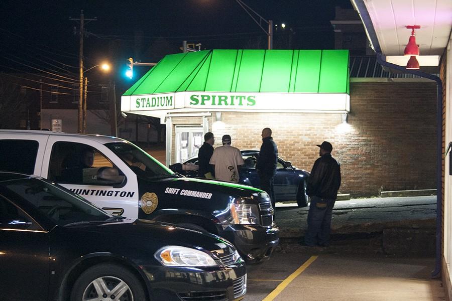 Responding officers investigate the reported gunshots fired around 7:30 p.m. outside of Stadium Spirits Tuesday, Feb. 23, 2016.