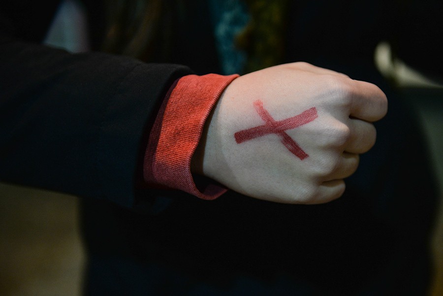 Marshall University students take turns standing outside the Memorial Student Center and sport red “Xs” on their hands in an effort to bring awareness to slavery and human trafficking on Thursday. The representatives spent a total of 27 hours to represent the 27 million currently enslaved.