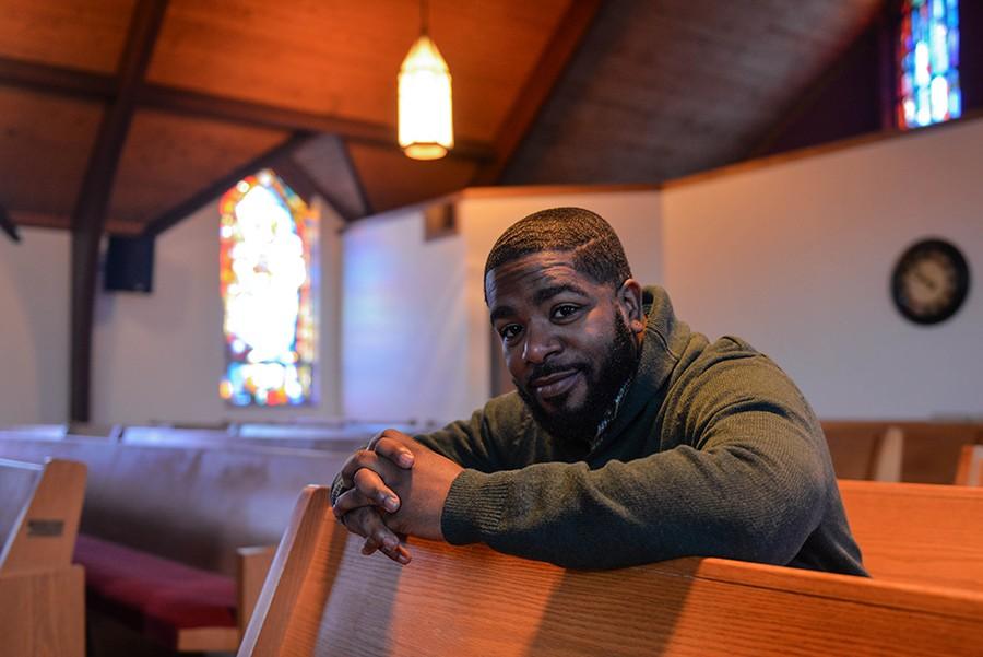 Reverend Donte L. Jackson sits in a pew inside First Baptist Church on Feb. 11.
