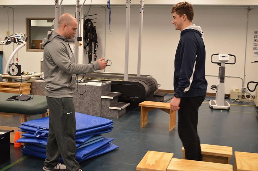 Hunter Perry, exercise science graduate student administers a step test to senior Eric Riley on Friday.