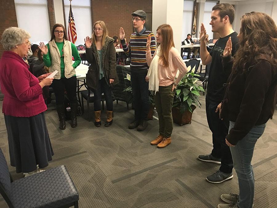 Carla Lapelle, interim dean of student affairs, swears in apprentices as senators at Student Government Association meeting.