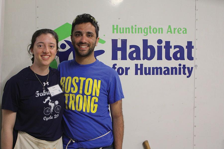 Kim Bretta, left, and Troy Vagianelis of Boston College volunteer during their spring break with the Huntington Area Habitat for Humanity to assist with constructing a home Friday.