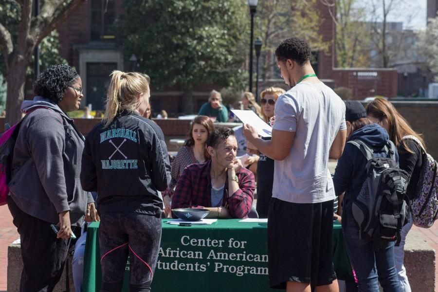 Students wait in line to register to vote Wednesday at the Memorial Student Center Plaza during Black United Students’ Rock the Vote event.