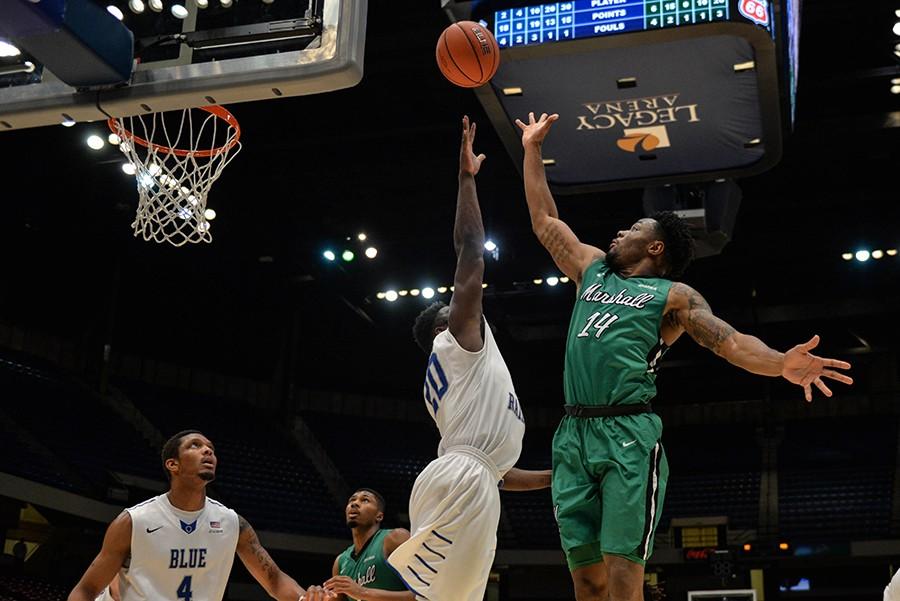 Marshalls C.J. Burks (14) attempts a floater against Middle Tennessee during the C-USA Men’s Basketball Semifinals.