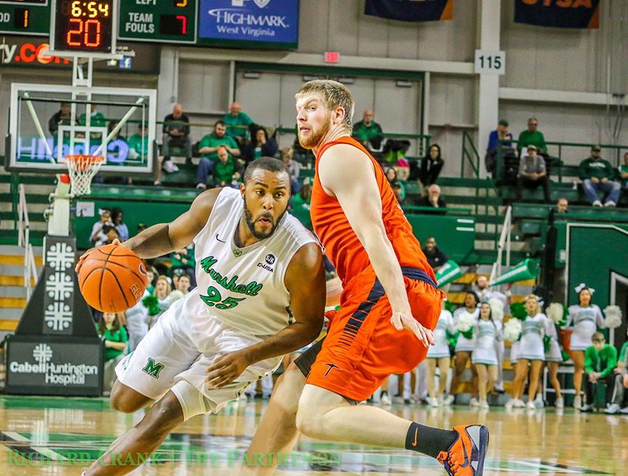 Junior forward Ryan Taylor drives past a defender in a game against UTEP last season. Taylor’s 14.4 PPG ranks third on the team this season.
