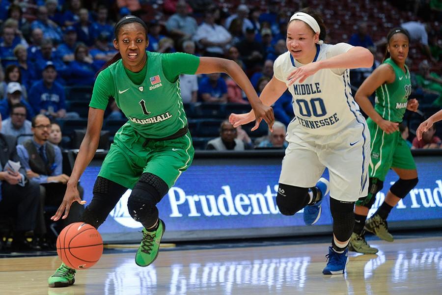 Senior forward Leah Scott drives past Middle Tennessee State’s Alex Johnson Friday in Marshall’s conference USA Tournament semifinals loss to the Blue Raiders.
