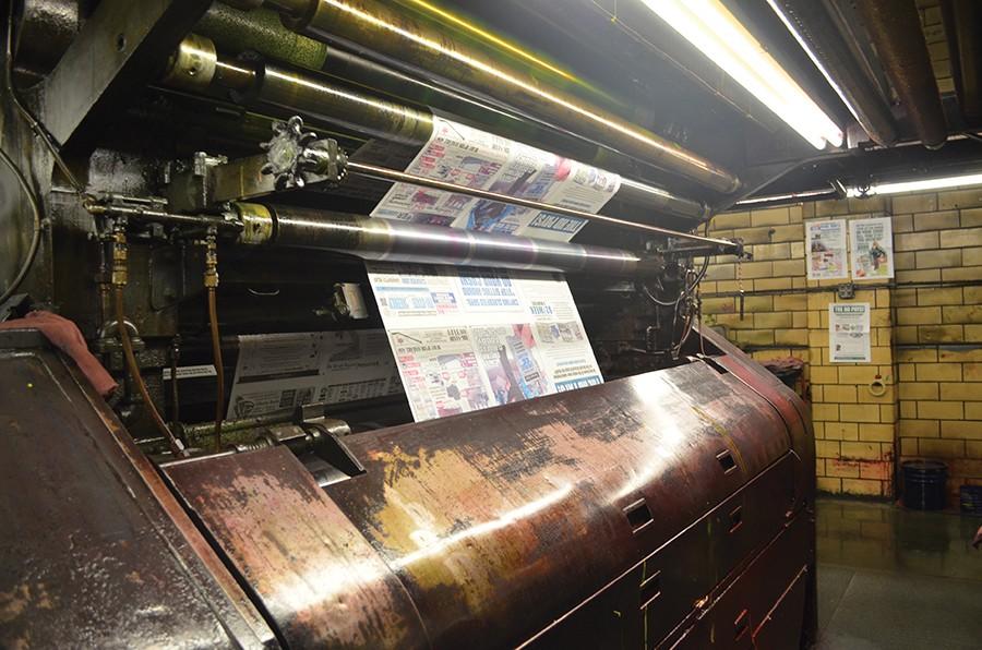The Herald Dispatchs built-in printing press churning out one of its final editions, April 1, 2016.
