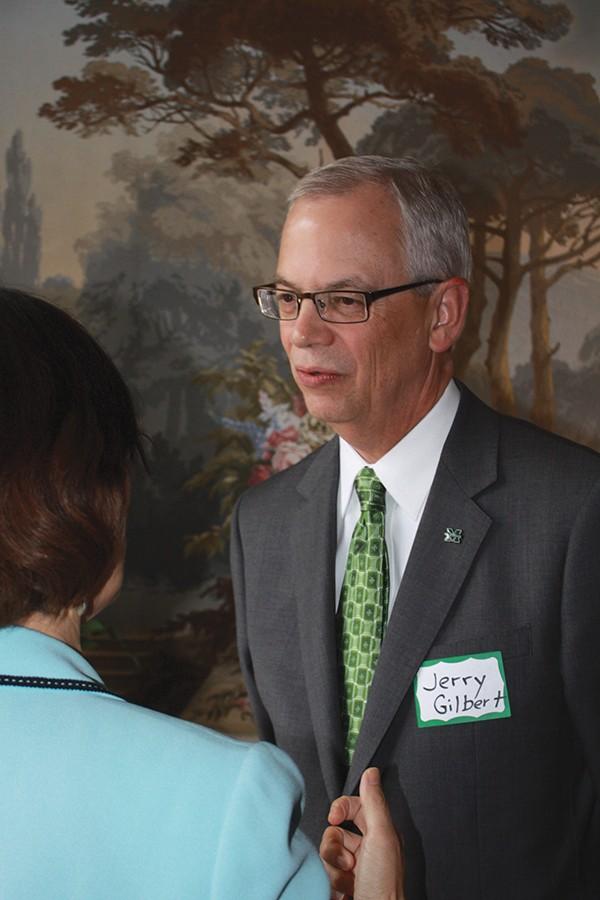 President Gilbert talks wih Director of Library Operations JingPing Zhang during Gilberts open house for faculty and staff at his home April 4, 2016.