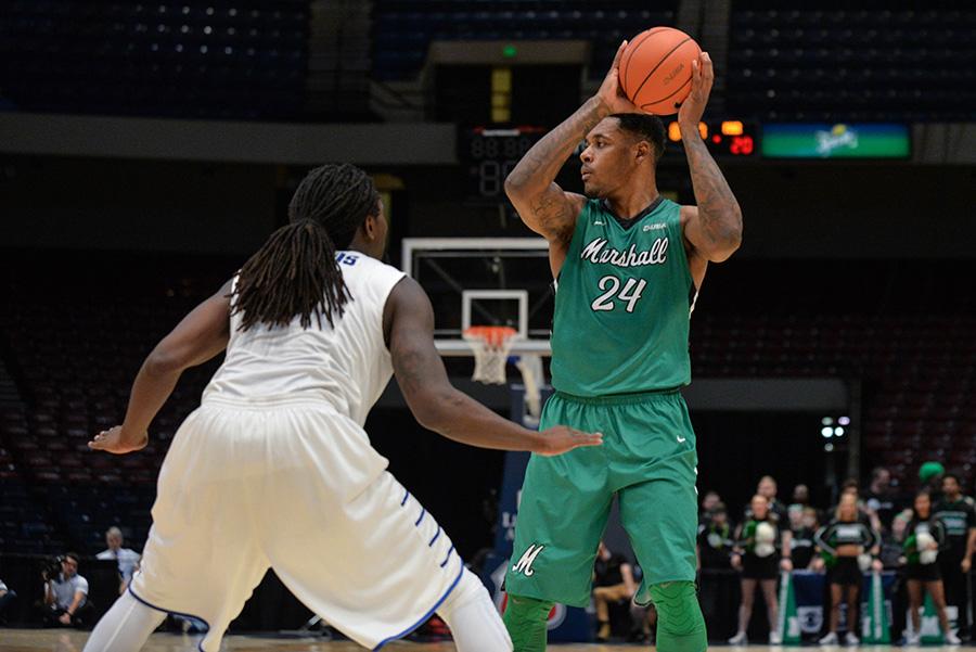 Marshall University senior James Kelly looks to make a move against a Middle Tennessee State University defender March 11 in the Conference USA Semifinals.