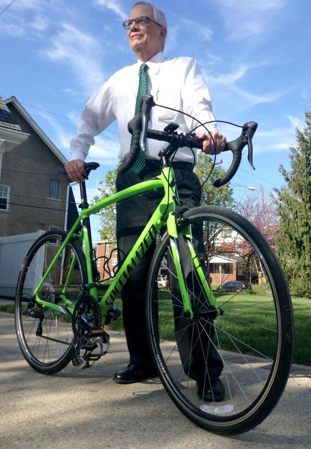 President Jerry Gilbert shows off the specialized, lime green Allez bicycle he bought this year to continue his cycling passion in Huntington.