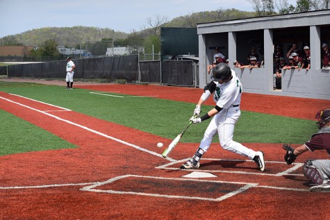 Marshall catcher Sam Finfer makes contact with a pitch in a game earlier this season.