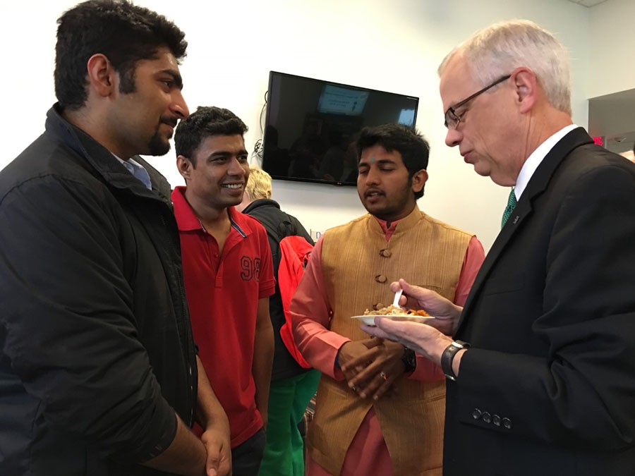 Marshall University President Gilbert enjoys an Indian cuisine while visiting the INTO: Marshall facility on Thursday for India Day.
