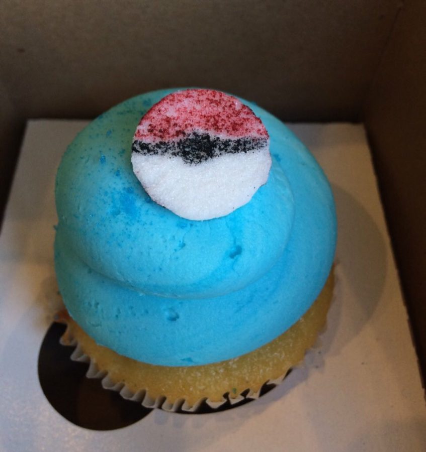 A blue "Team Mystic" cupcake is displayed in Paula Vega Cakes Wednesday.