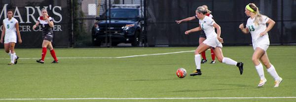 Sophomore Jayne Lawman runs the ball alongside junior McKenna Klodnick during the match versus Western Kentucky University at the Hoops Family Field, September 15, 2016.