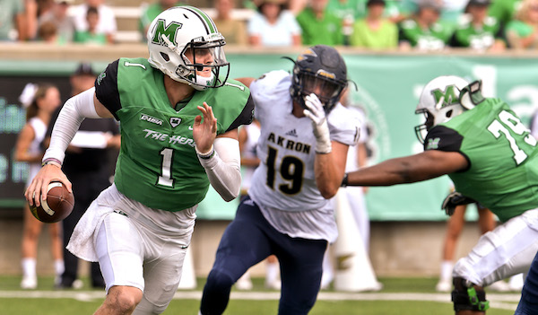 All dressed up and nowhere to go, Marshall University QB Chase Litton scrambles and looks for a receiver with Akrons Daumantis Venckus in hot pursuit during the second half action Saturday afternoon that saw Marshall go down to defeat 65-38 at Joan C. Edwards Stadium in Huntington. Bob Wojcieszak/Parthenon