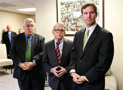 West Virginia Attorney General Patrick Morrisey, from left, Ohio Attorney General Mike DeWine, and Kentucky Attorney General Andy Beshear address the media before the start of a conference titled, ìTaking Back Our Communities: Combatting the Opioid Crisis,î on Thursday, Oct. 27, 2016, at New Life Church in Huntington, W.Va. The conference was attended by dozens of law enforcement officers, health care professionals and faith-based groups. (Sholten Singer /The Herald-Dispatch via AP)