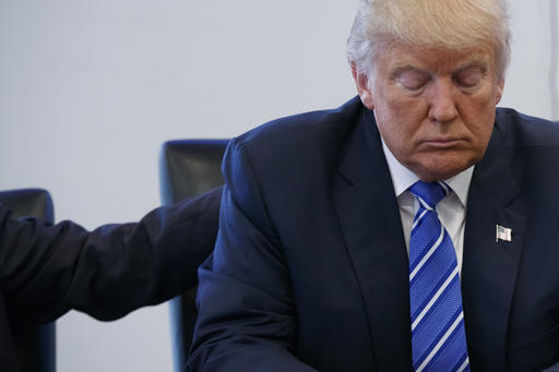 File-This Oct. 7, 2016, file photo shows Republican presidential candidate Donald Trump pausing during a meeting with members of the National Border Patrol Council at Trump Tower in New York. A defiant Trump insisted Saturday, Oct. 8, 2016, he would "never" abandon his White House bid, rejecting a growing backlash from Republican leaders nationwide who disavowed the GOP's presidential nominee after he was caught on tape bragging about predatory advances on women. (AP Photo/ Evan Vucci, File)