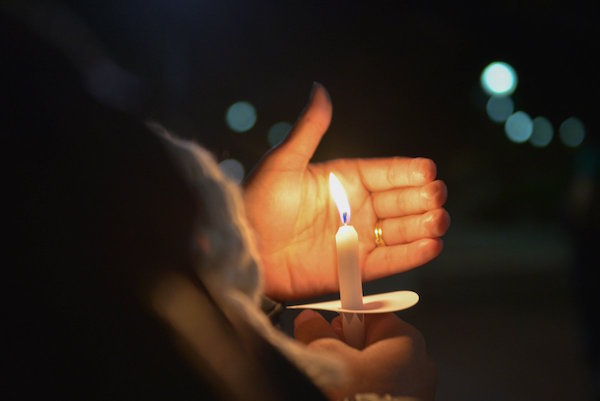 Silenced Americans speak out at candlelight vigil