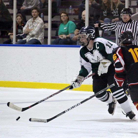 Marshall hockey captain Steven Macuch (11) brings the puck up the ice in an away game against the Wheeling Jesuit Redbirds. 