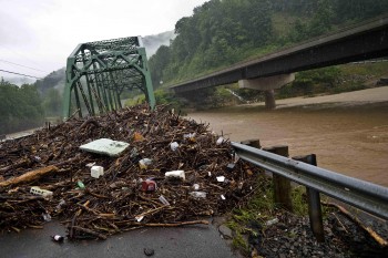 The raging Gauley River passes under a bridge filled with debris June 2016, the day after floods devastated parts of Southern West Virginia.