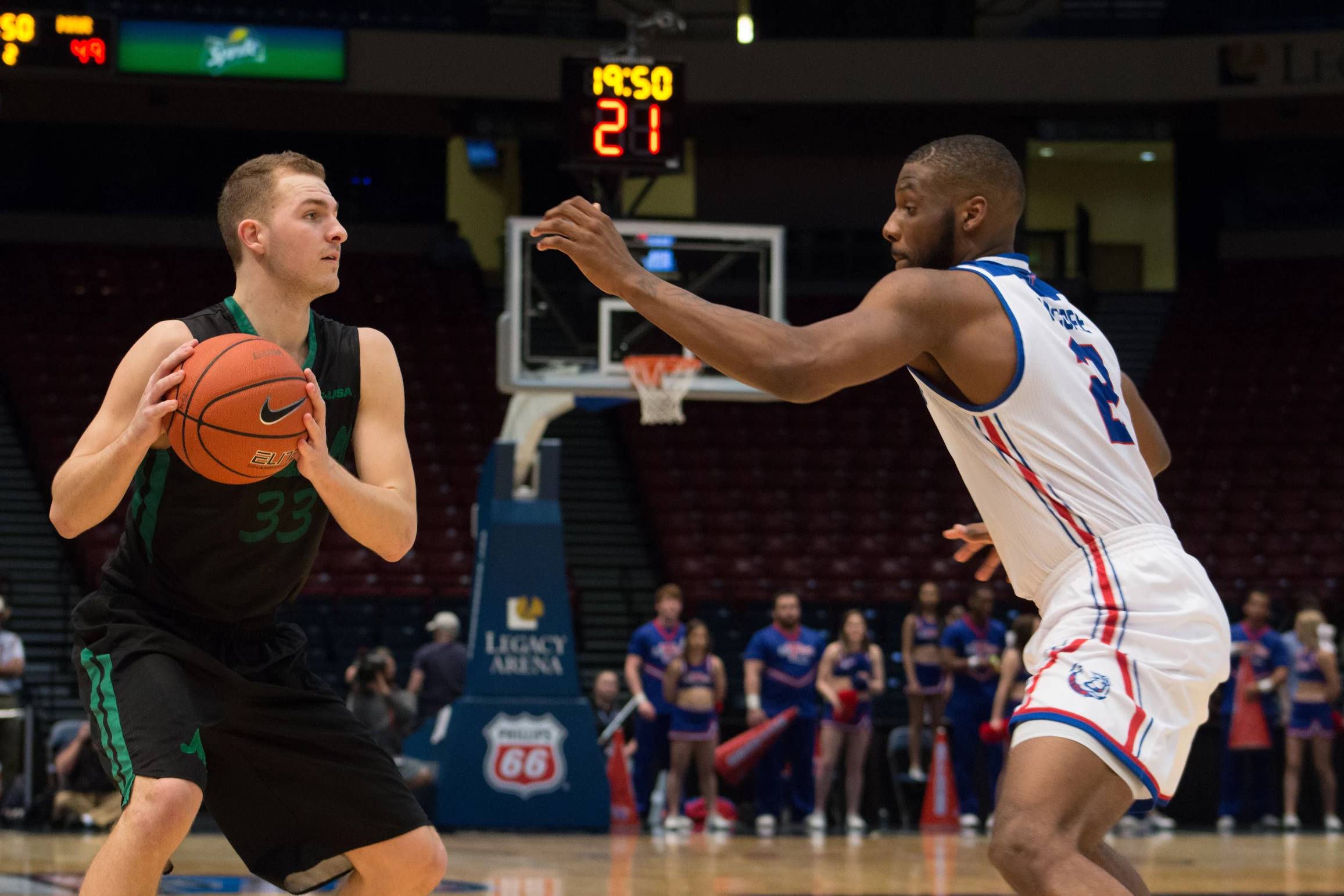 Marshall guard Jon Elmore (33) looks for an open teammate Friday afternoon against Louisiana Tech in the Conference USA semifinal round. Marshall upset the Bulldogs, 93-77, to advance to their second-ever C-USA championship game.