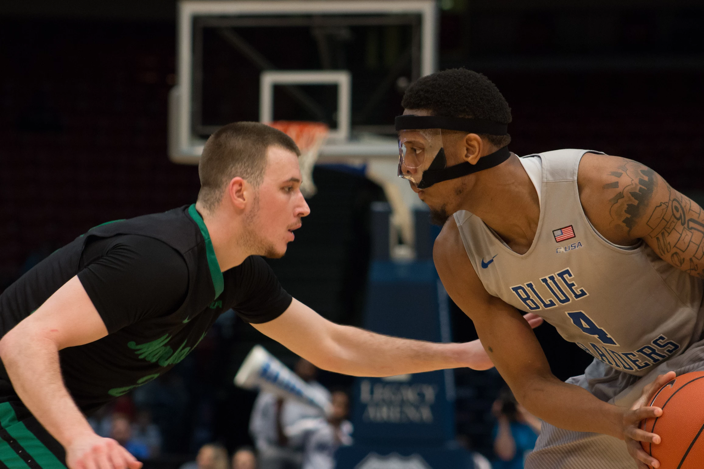 Marshall guard Stevie Browning (2) guards Middle Tennessee guard Xavier Habbersham (4) Saturday night in the Conference USA men's basketball championship game. Marshall fell to the Blue Raiders 83-72.