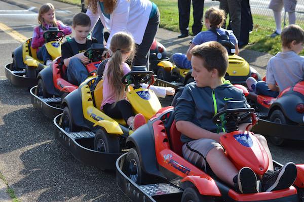 Children test out new cars at Safety Town while learning the rules of traffic safety. 