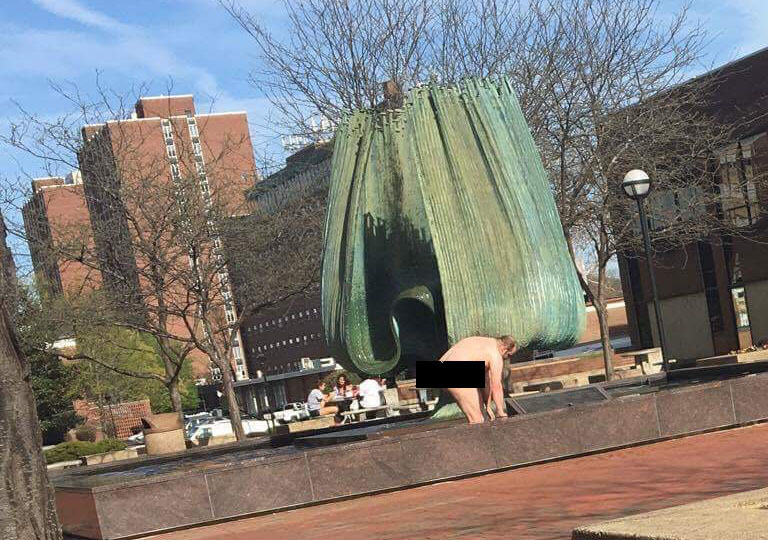 Man bathing in the Marshall Memorial Fountain Sunday afternoon.
