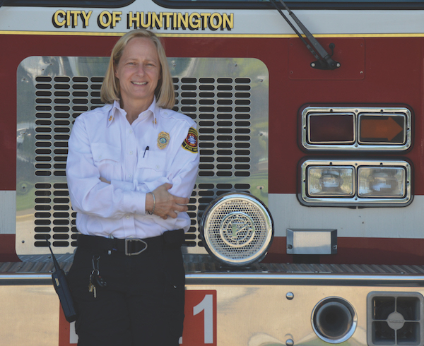 Rader stands in front of a Huntington fire engine. 