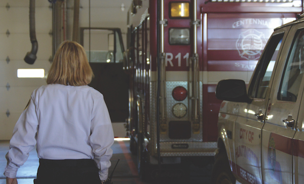 Jan Rader walks towards a fire engine. Rader has worked since 1994 serving the public in a variety of ways.
